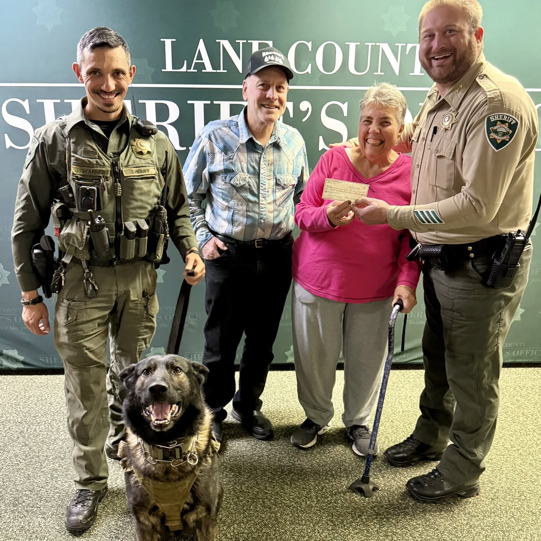Lane County Sheriff's K-9 deputy with community members and Sheriff's staff